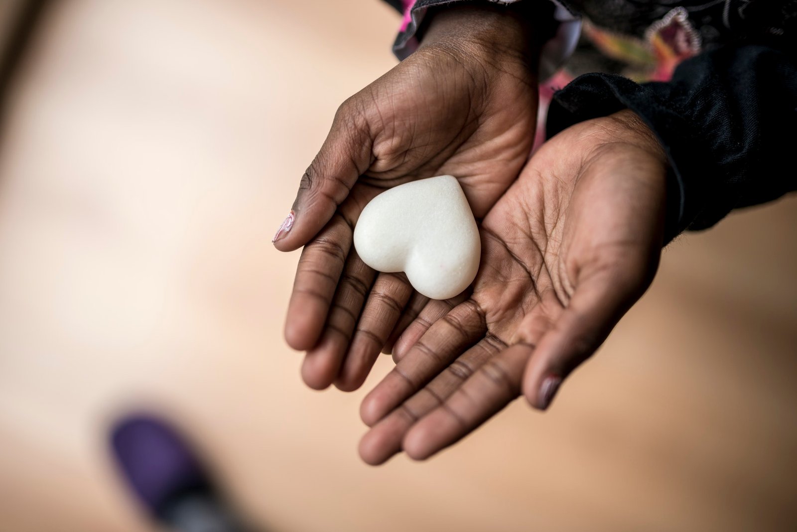 african american girl hands holding a marble made heart